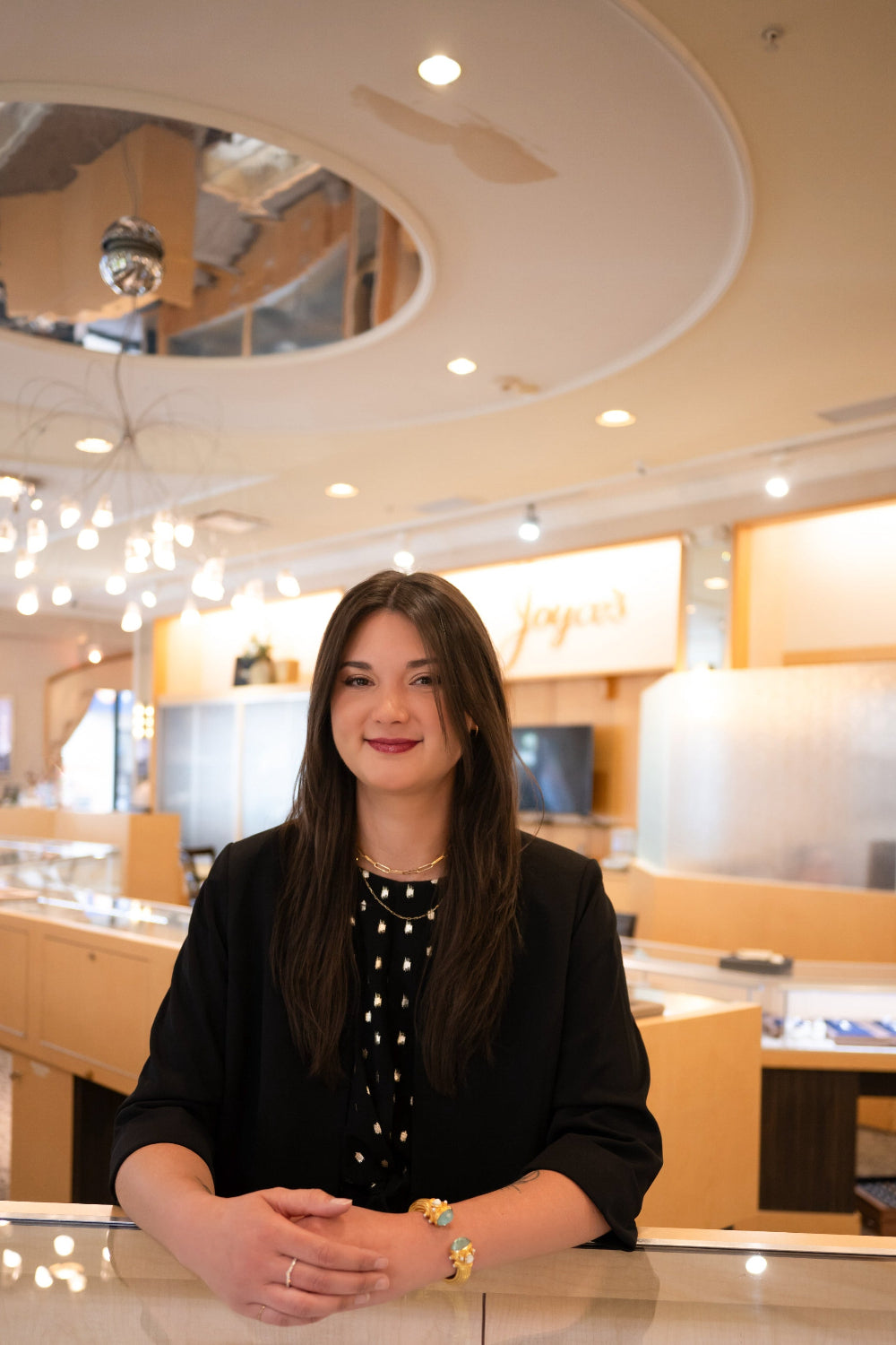 Woman standing behind a counter in a modern interior setting