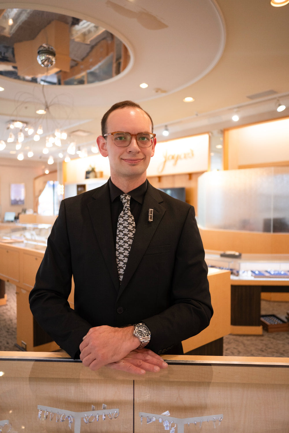 Man in a suit standing in a modern interior setting